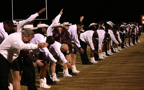 The Lariettes perform a routine to Train with their fathers during halftime.