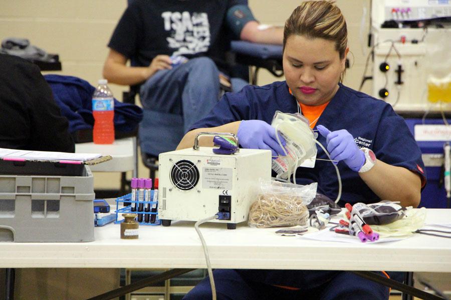 One of the blood drive technicians organizes the donated blood. Photo by Arturo Compean.