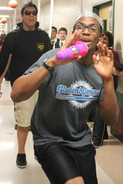 Walter Goldsberry and Ty Hoang dance their way down the hall