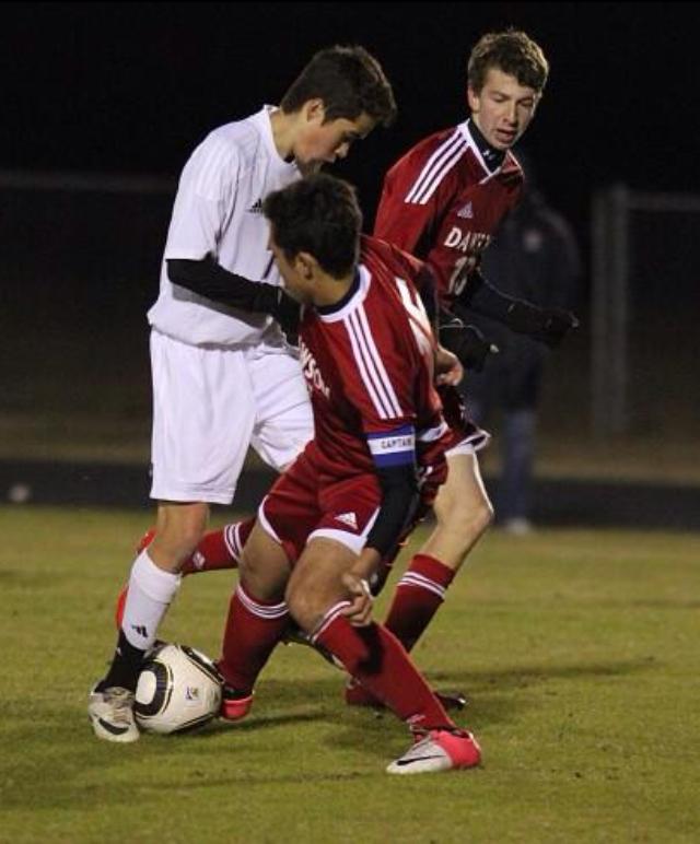 Matt Vasquez takes on two defenders