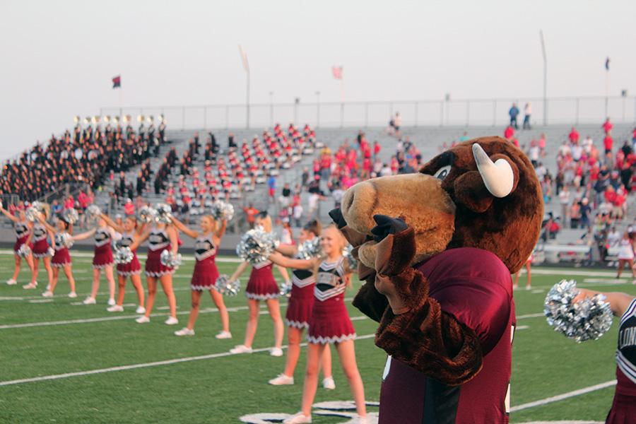 School Mascot and cheerleaders pump up the crowd before the game