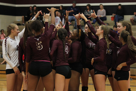 The team gets together for their last home game huddle of the year.