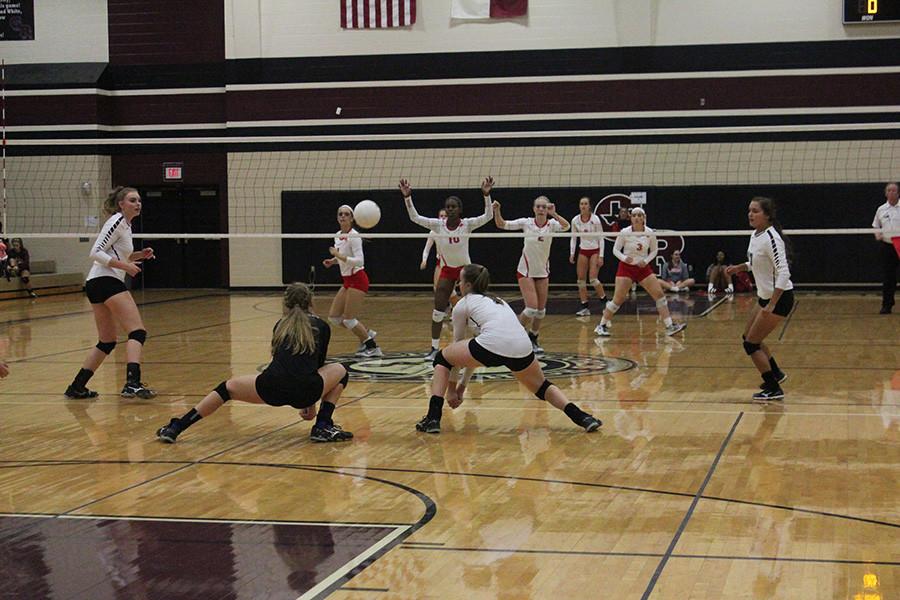 Audrey Tuttle and Valerie Valerian go in for a dig.  