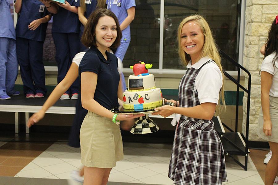 (From Left to Right): Nora Harrison, Karissa Wilson presenting their Senior Serve cake. Their cake sold for $5,000.