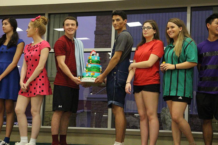 (From Left to Right): Chloe Oesterreich, Tayelor Bade, David Kvinta, Michael Elder, Laura Green, Cameron Lavine, Noah Joe displaying their themed cake for the live cake auction.
