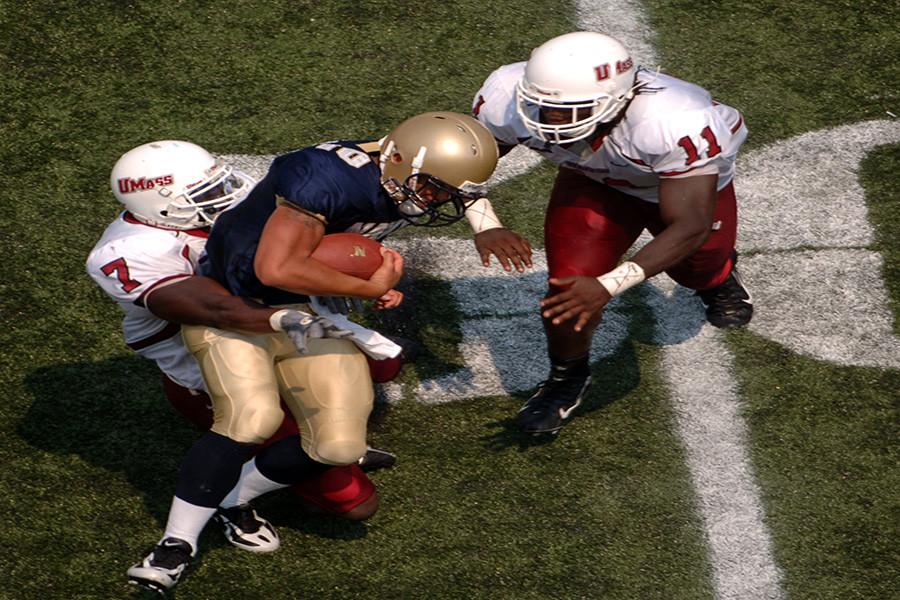 060909-N-9693M-010
Annapolis, Md. (Sept. 9, 2006) - Navy Quarterback Kaipo-Noa Kaheaku-Enhada is tackled by Massachusetts defensive back James Ihedigbo, #7, and linebacker Charles Walker, #11. The Navy Midshipmen (2-0) triumphed over the UMass Minutemen (1-1) 21-20. U.S. Navy photo by Damon J. Moritz (RELEASED)