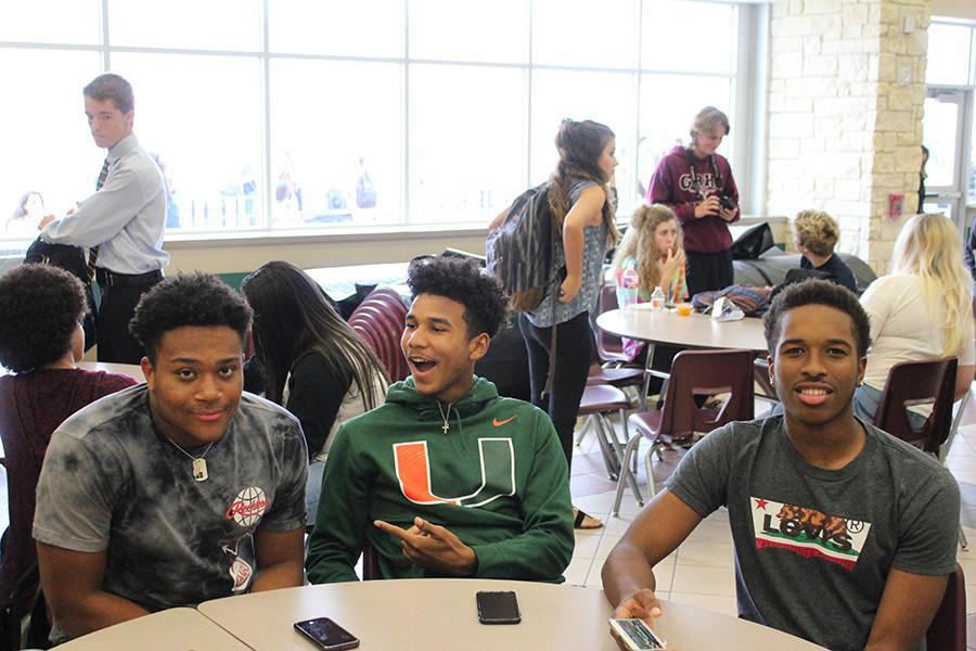 football players take a picture at lunch