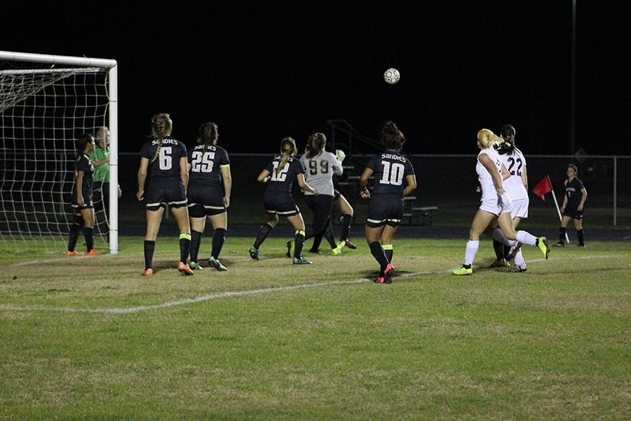 Everyone waits patiently, in anticipation as the ball descends towards the ground