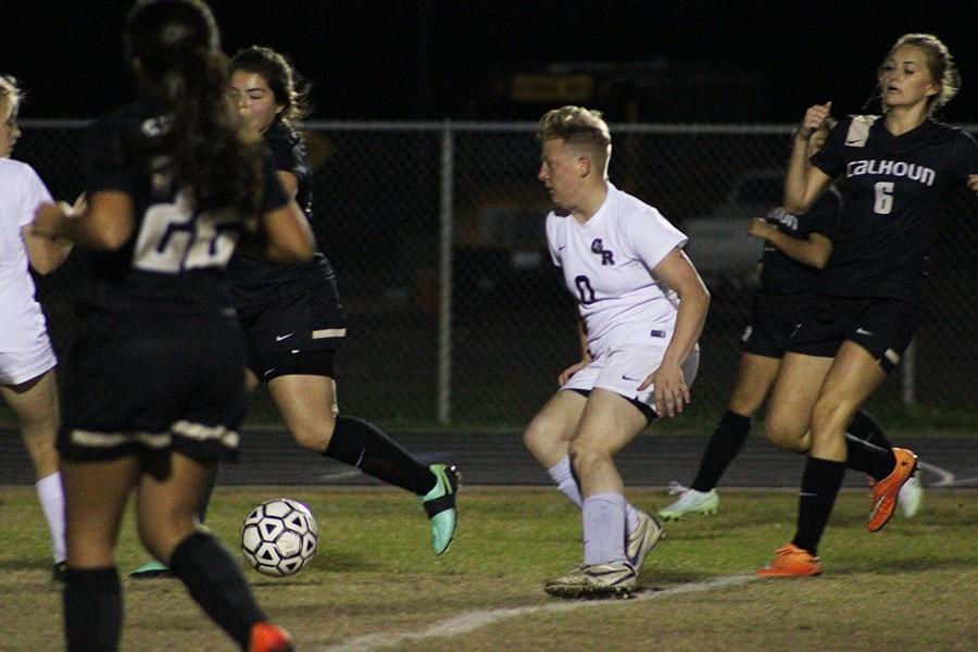 Senior Michelle Mills dribbles the ball down the field in hopes of scoring a goal