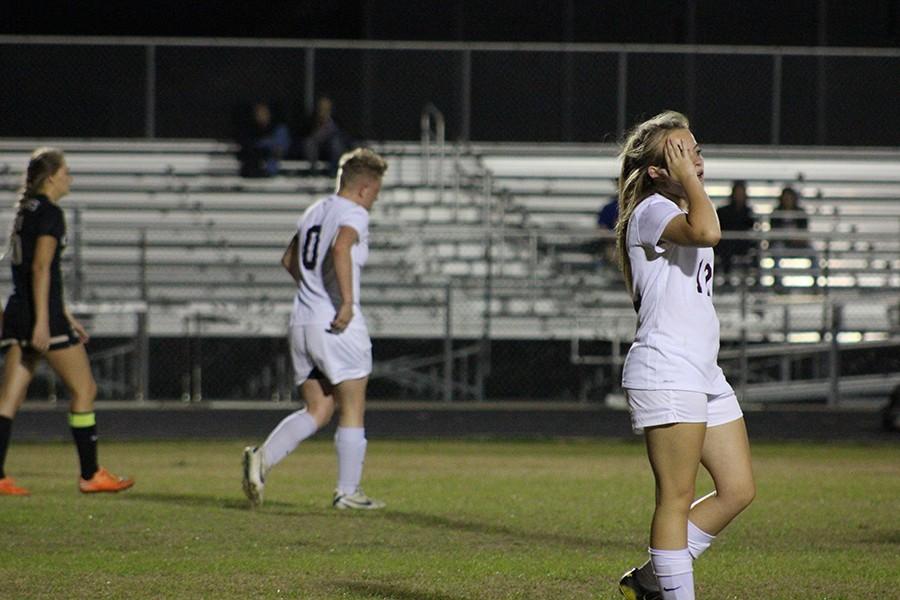 Seniors Michelle Mills and Madi Nicholson get into position during the game