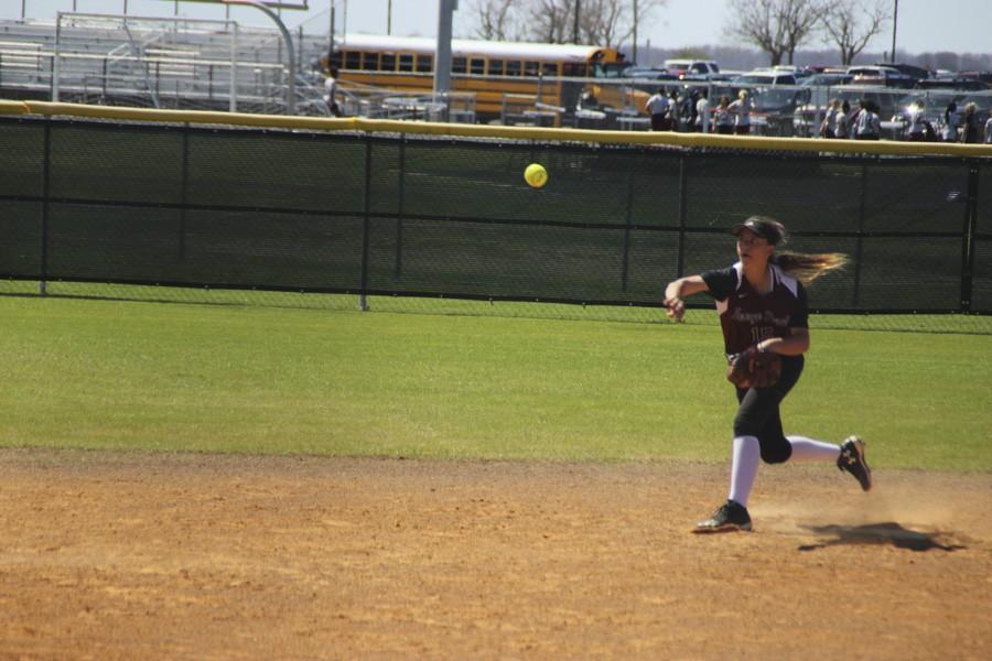 Destiny Walker throws the ball to get the girl out at third. 