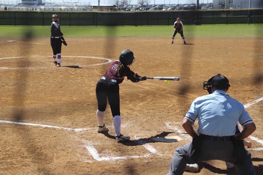 Lily Pearson stretches to reach a curve ball that's off the plate. 