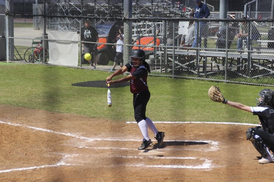 Kayte Martinez launches a ball back at the pitcher. 