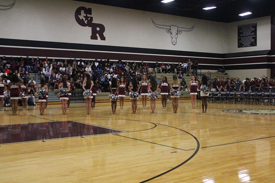 The Lariettes stand in lines and get ready to introduce the Varsity Volleyball girls into the gym.