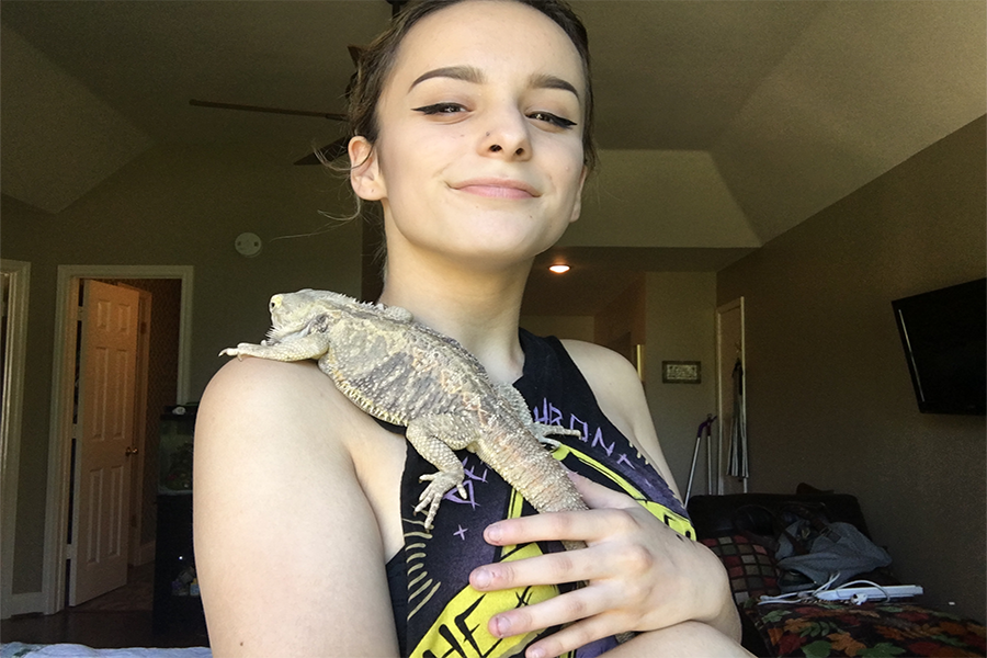 Haley Lumbert stands proudly with her bearded dragon, Puff Daddy, on her shoulder.