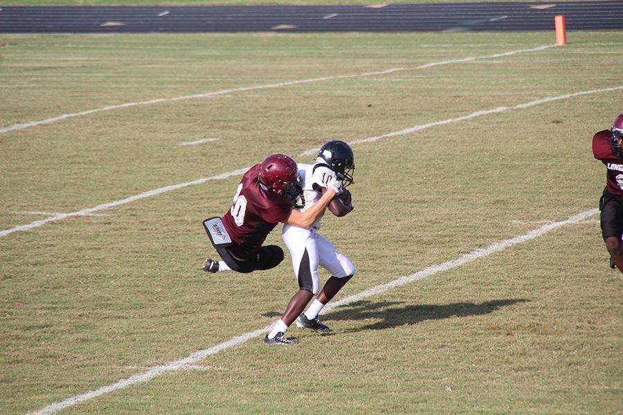  A Longhorn tackles a player from the opposing side.