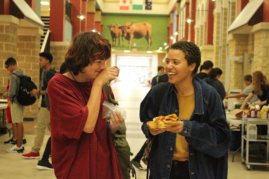 Nathan Chong and Jadelyn Bryan, a couple, laugh about the awkwardness while eating nachos.