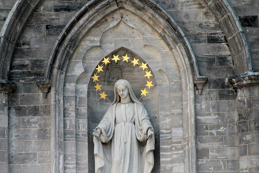 Statue of a saint looking down on the people of the church.