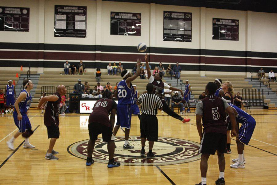 Two players fight for the ball during the tip-off.