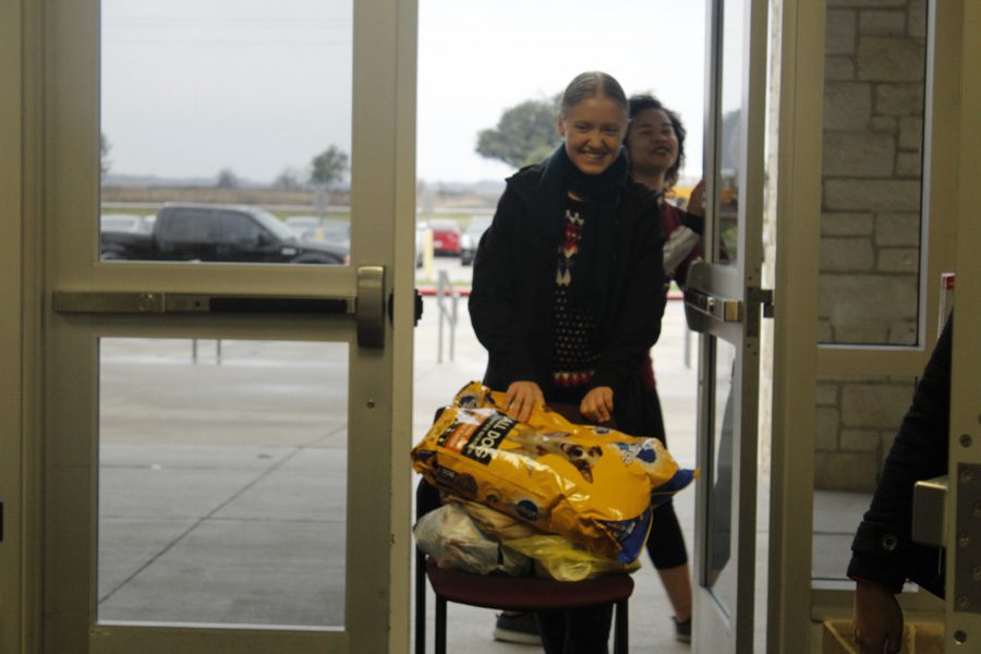 HOSA student assisting in the load-up of donations to the bus.