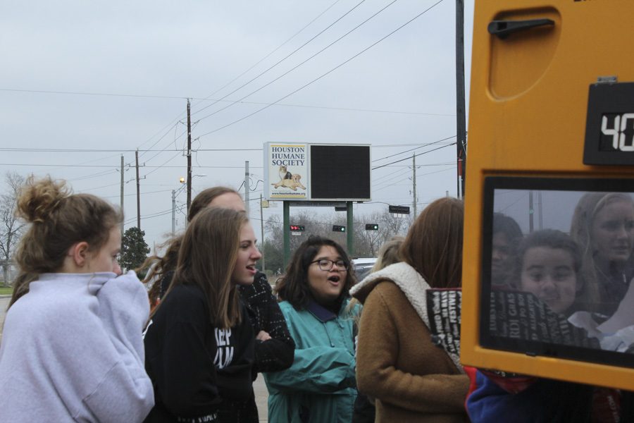 Students huddling together as an attempt to stay warm as they unload.