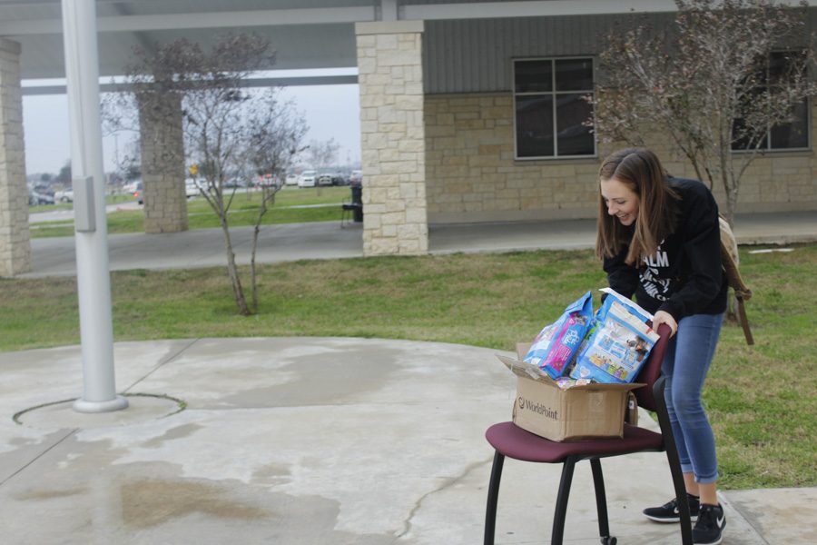 Student laughing through her pain of the cold weather.