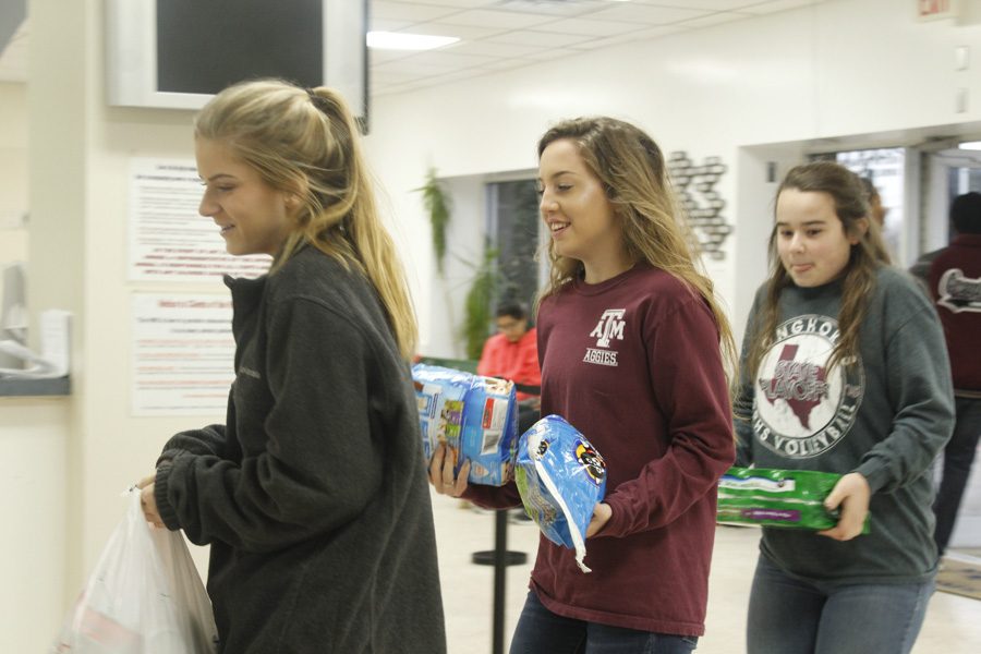 Students helping unload the bus with their donations.