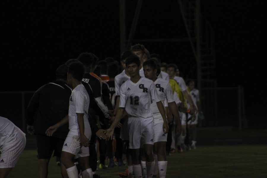 The teams shake hands