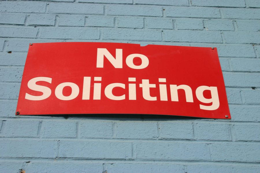 A No Soliciting sign on a wall. 