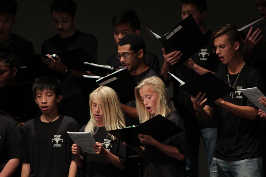 Ben  and Turner stood together singing the regional pieces.