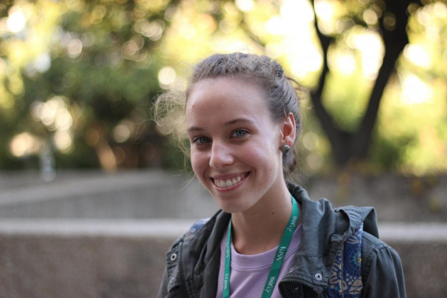 A girl smiling at the fact that she gets to learn how to use a Lensbaby.