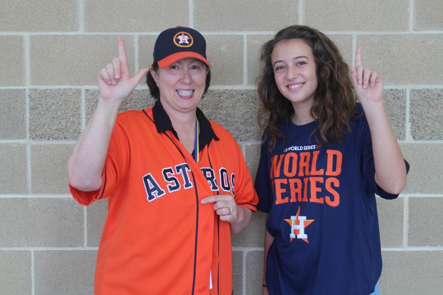 Mrs. Harris and a student cheer them on.