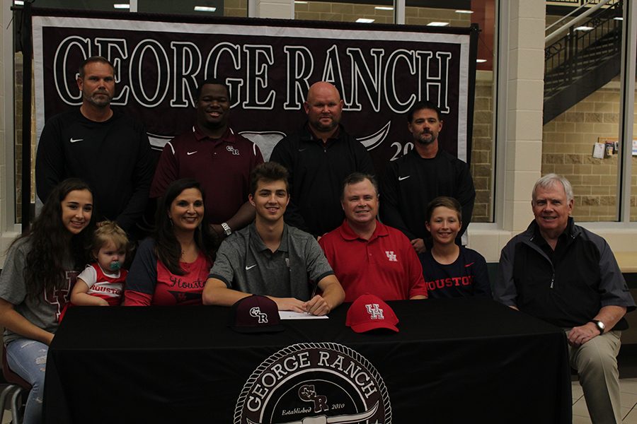 Cole McMillan with his coaches and principal.  