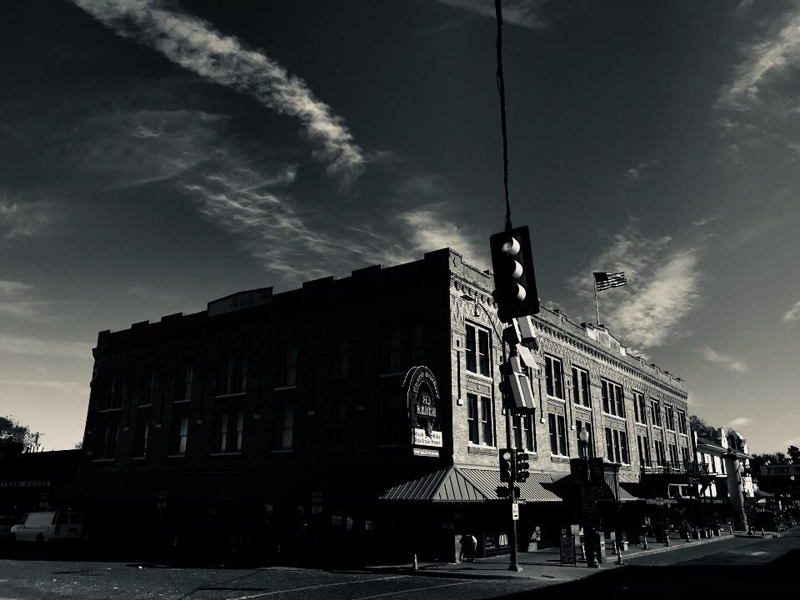 A lone traffic light blows in the wind