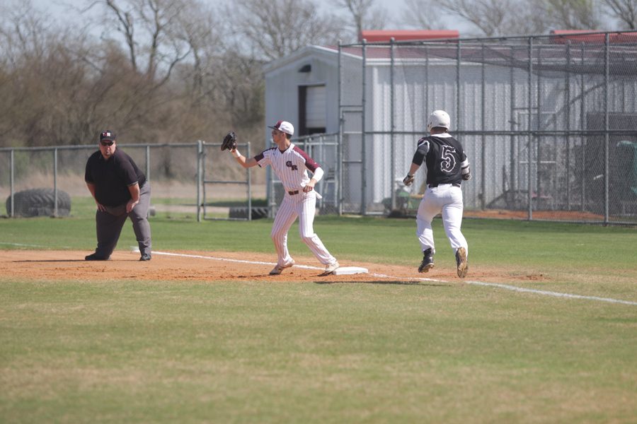 First Baseman Cole McMillan receives a throw to get an out at first