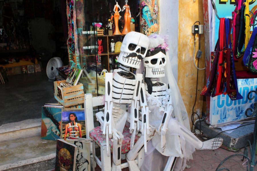 A statue outside of a shop in Playa De Carmen, Mexico surrounded by Frida Kahlo artwork for sale. 