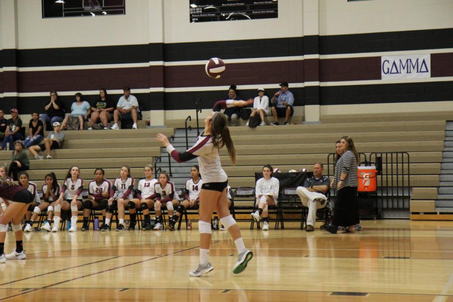 Avery Webb (9) serves the ball to Foster. 