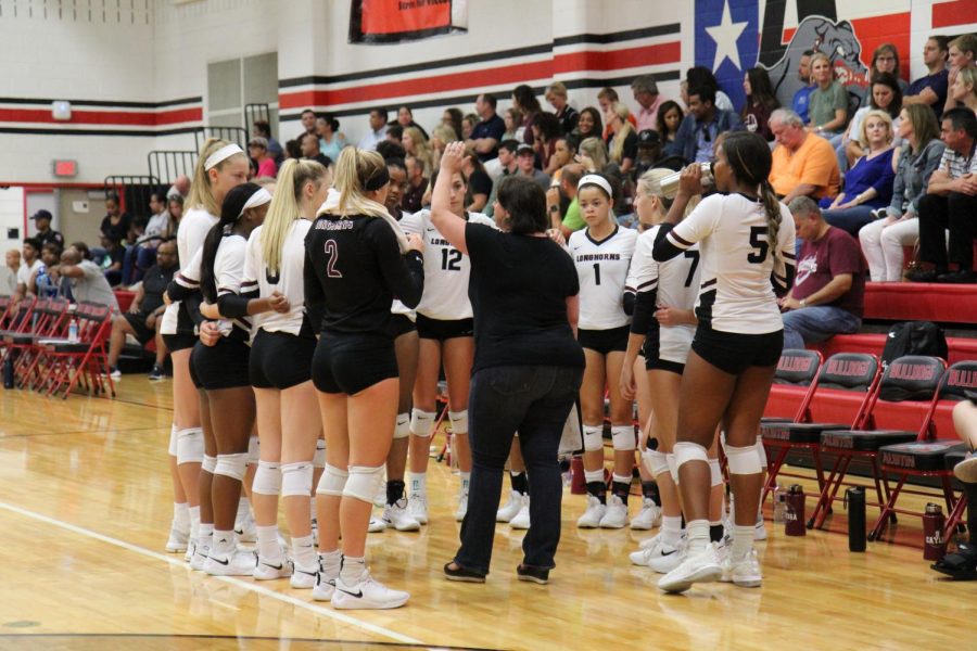 Varsity coach Forshee huddled up with the varsity team. 