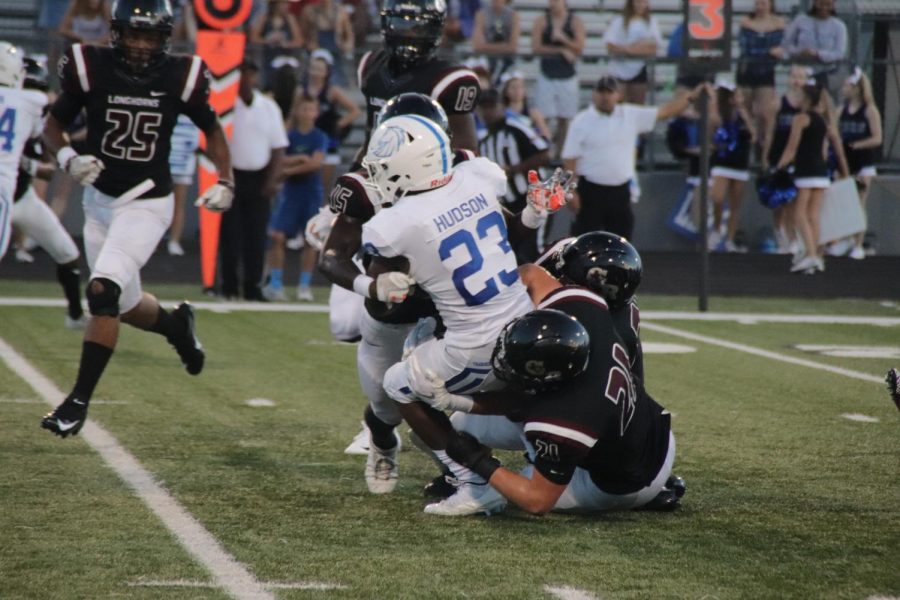 Braden Turner(12) and Bryce Ramirez(12) gang up on the running-back to get the assist tackle.  