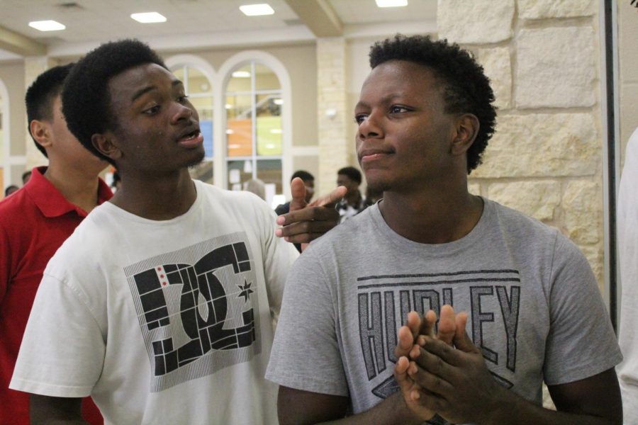 Jacori Gray (11) and Sam Shackelford (11) have a conversation while waiting for lunch