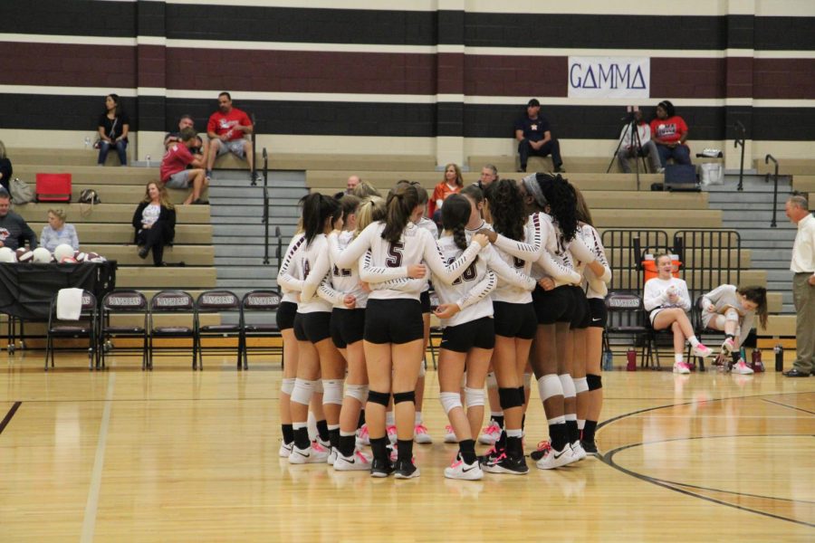 JV team huddling together before a tough match against Dawson.