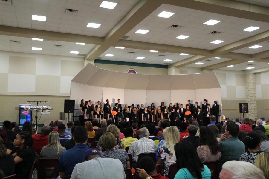 Varsity chorale singing for the audience.