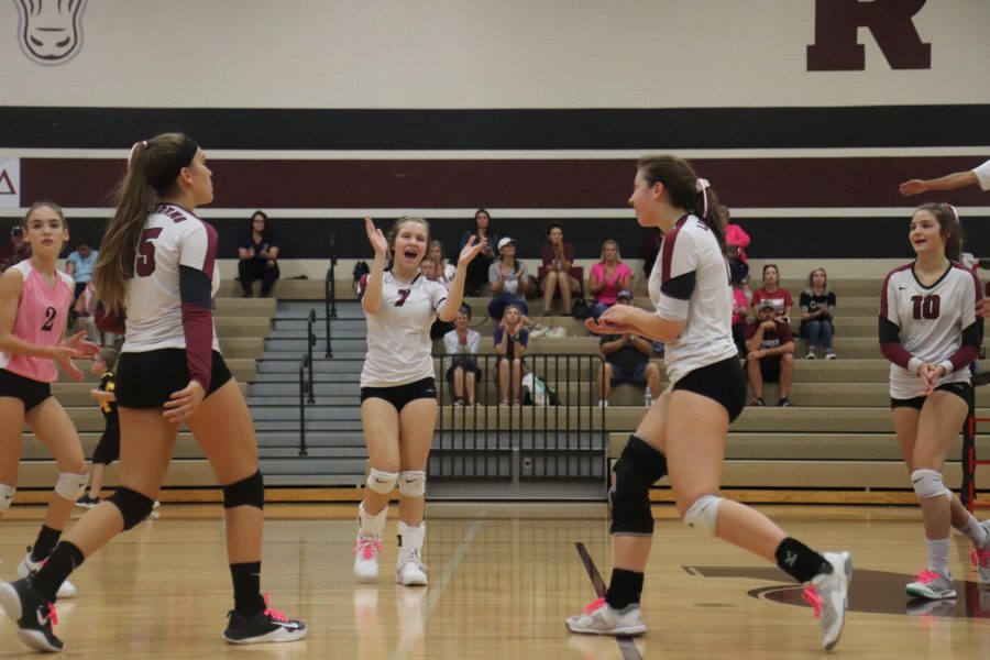 Freshman team celebrating after a good point.