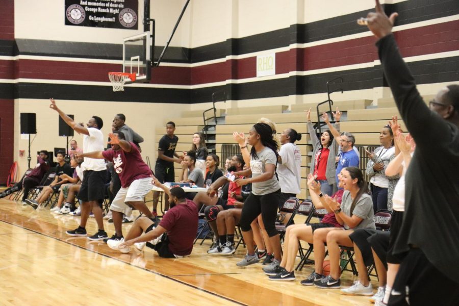 The teachers and staff on the sidelines excited after a good lead.