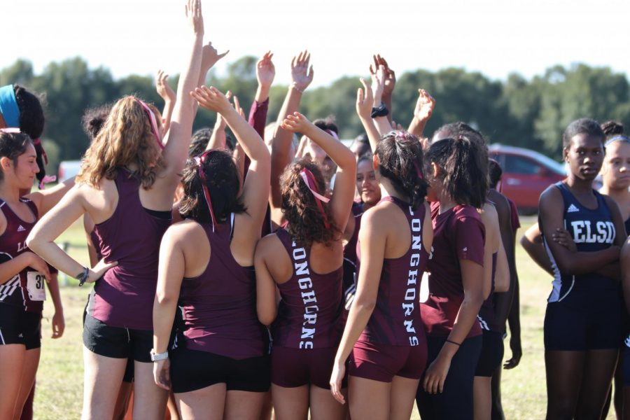 The JV team breaking out their huddle before the race begins.