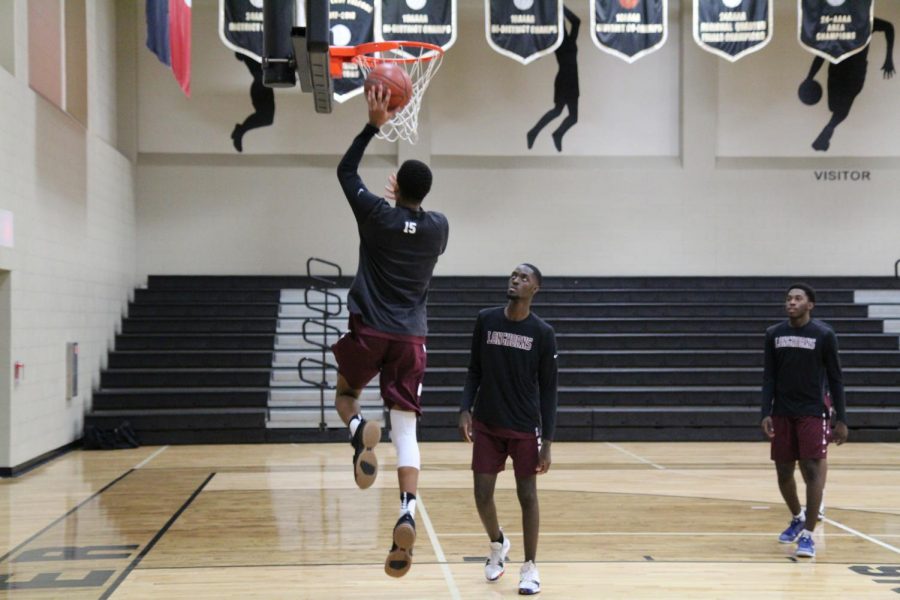 Dominic Dixon (11) warming up with a couple lay ups.