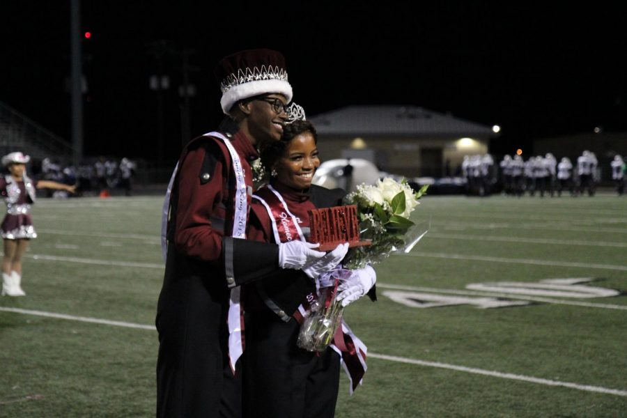 Jalen Archer (12) and Faith Jordan (12) posing with Mr. Toups believe sign.