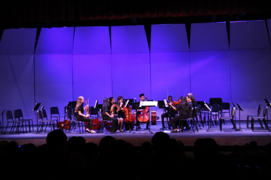 Orchestra+students+preforming+a+piece+for+their+first+concert.+