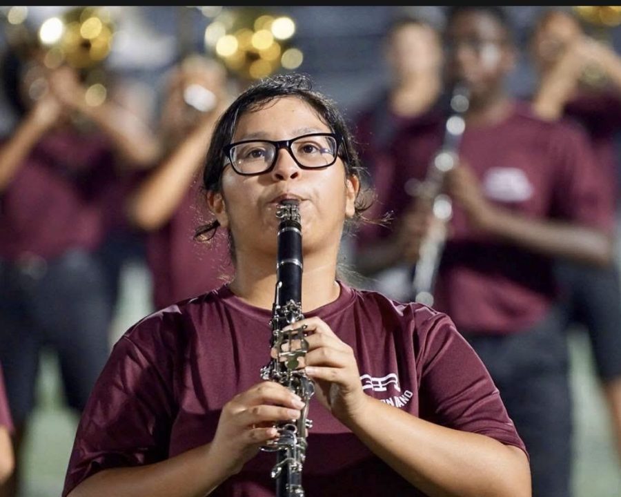 Angela Gonzales performing the marching show on clarinet.