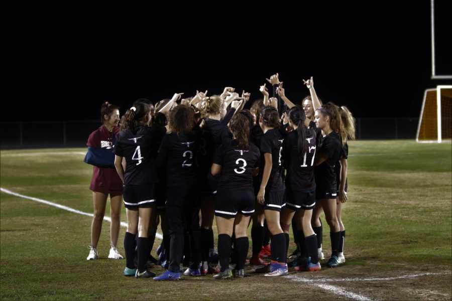 The Girls Varsity Soccer team pepping up before the game. 